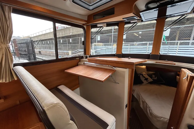 Slide: The Image of Interior of 2017 Ranger Tugs R-31 CB with wood accents and seating area. - 26