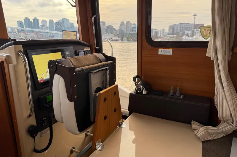 Slide: The Image of Interior view of 2017 Ranger Tugs R-31 CB with city skyline through window. - 29