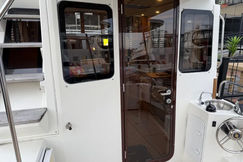Slide: The Image of 2017 Ranger Tugs R-31 CB boat interior view with stairs and kitchenette. - 3