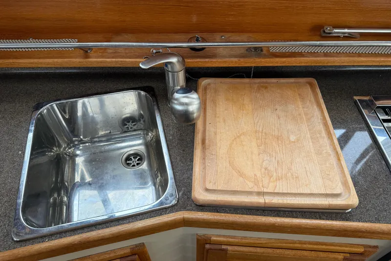 Slide: The Image of 2017 Ranger Tugs R-31 CB kitchen sink and cutting board setup. - 32