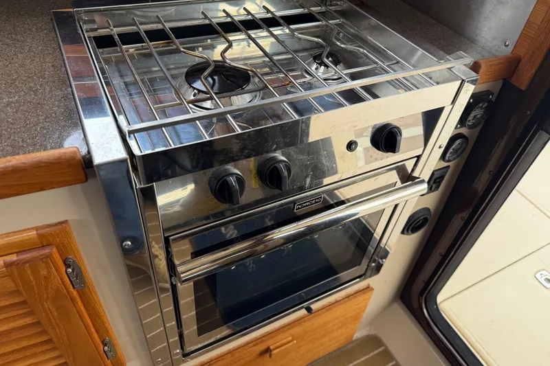 Slide: The Image of Stainless steel stove and oven in 2017 Ranger Tugs R-31 CB boat kitchen. - 33