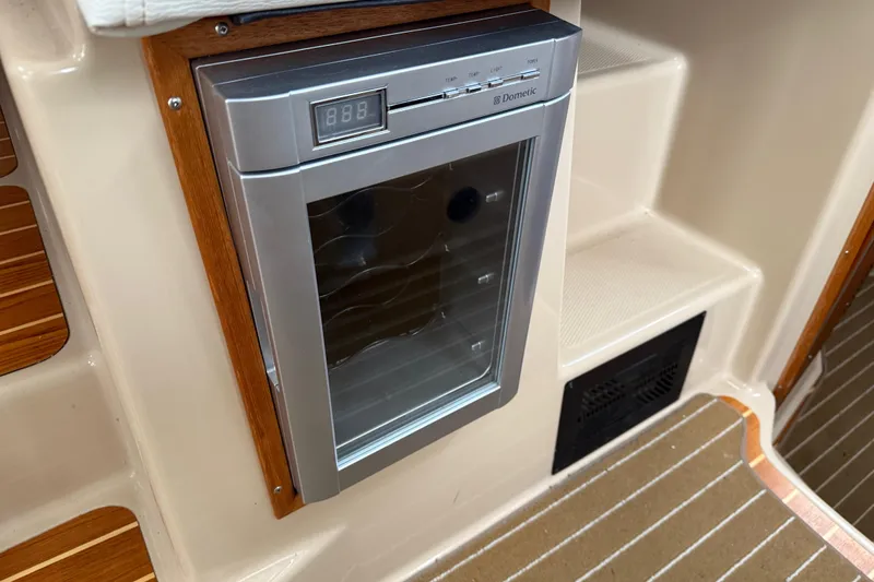 Slide: The Image of 2017 Ranger Tugs R-31 CB interior with Dometic fridge, wood accents, and steps. - 39