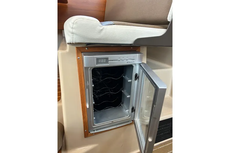 Slide: The Image of 2017 Ranger Tugs R-31 CB interior with open Dometic wine cooler. - 40