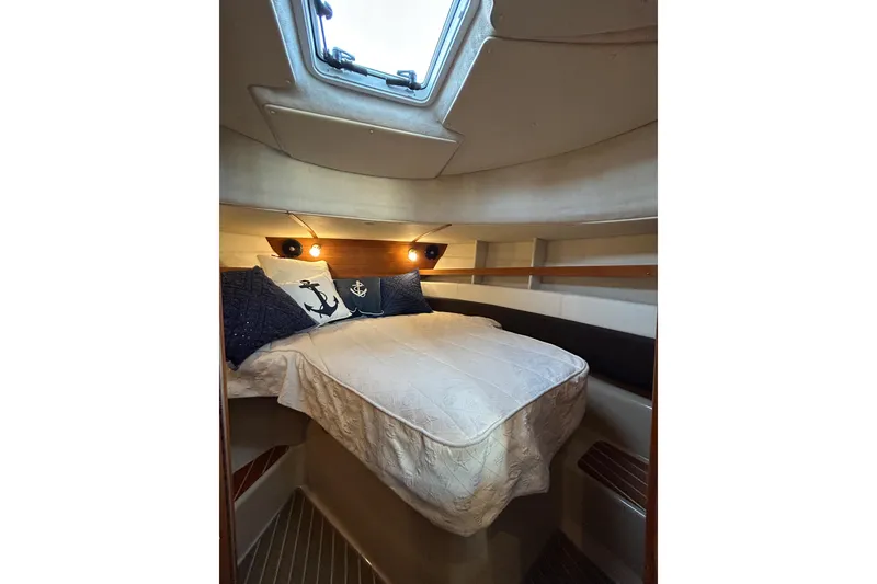 Slide: The Image of Cozy cabin interior of 2017 Ranger Tugs R-31 CB with nautical-themed bedding. - 42
