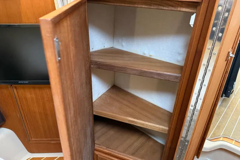 Slide: The Image of 2017 Ranger Tugs R-31 CB interior with wooden cabinet and shelves. - 45