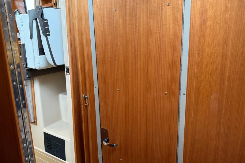 Slide: The Image of Interior of 2017 Ranger Tugs R-31 CB with wooden door and storage compartment. - 46