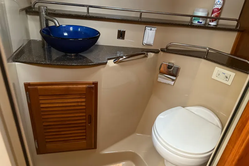 Slide: The Image of 2017 Ranger Tugs R-31 CB bathroom with blue vessel sink and compact toilet. - 49