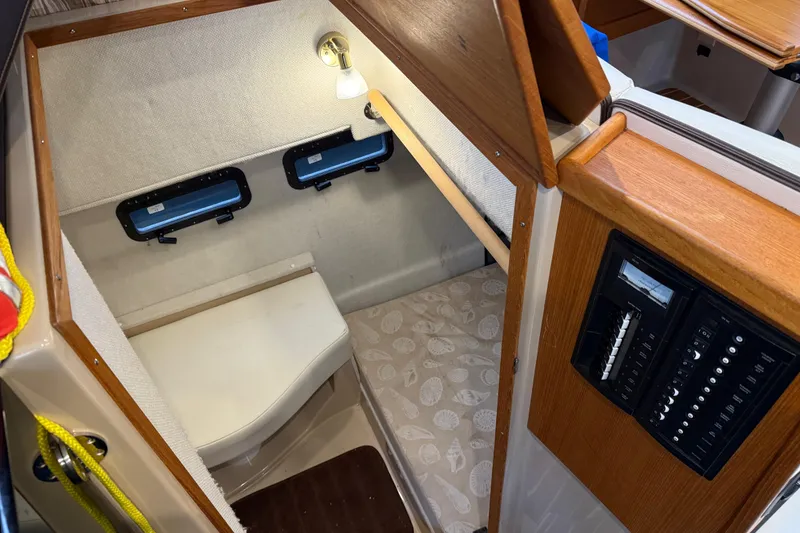 Slide: The Image of 2017 Ranger Tugs R-31 CB cabin interior with cozy sleeping area and control panel. - 50