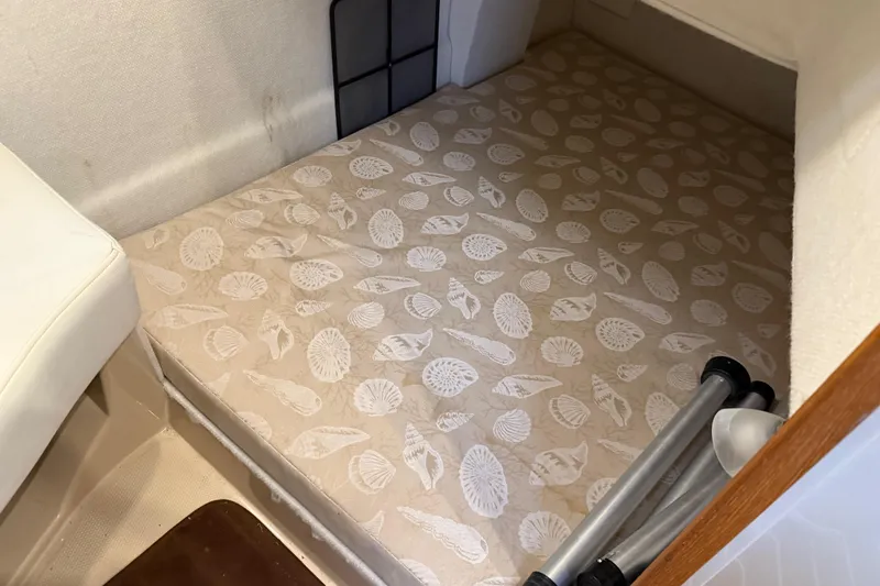 Slide: The Image of 2017 Ranger Tugs R-31 CB cabin interior with patterned mattress and storage space. - 54