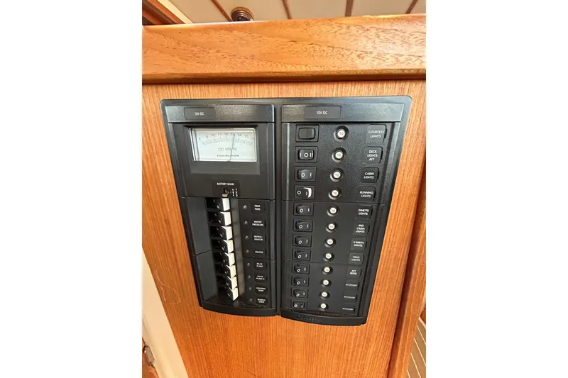 Slide: The Image of Electrical panel on 2017 Ranger Tugs R-31 CB boat, featuring switches and voltage meter. - 56