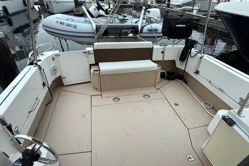 Slide: The Image of 2017 Ranger Tugs R-31 CB boat deck with seating and docked inflatable dinghy. - 60