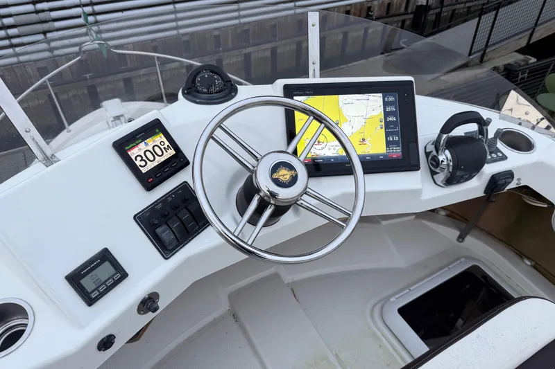 Slide: The Image of Cockpit of 2017 Ranger Tugs R-31 CB with navigation equipment and steering wheel. - 73