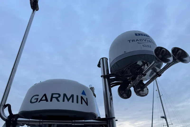 Slide: The Image of Garmin and TracVision equipment on 2017 Ranger Tugs R-31 CB boat against cloudy sky. - 81