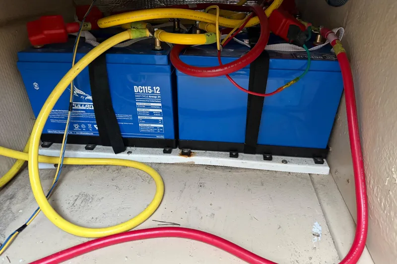 Slide: The Image of Battery compartment of 2017 Ranger Tugs R-31 CB with cables and deep cycle batteries. - 83