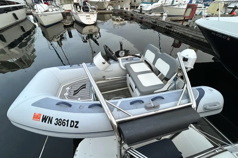 Slide: The Image of Inflatable boat docked at marina, near Ranger Tugs R-31 CB, 2017 model. - 84