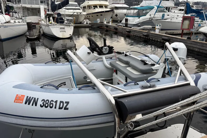 Slide: The Image of A 2017 Ranger Tugs R-31 CB docked among various boats in a marina. - 85