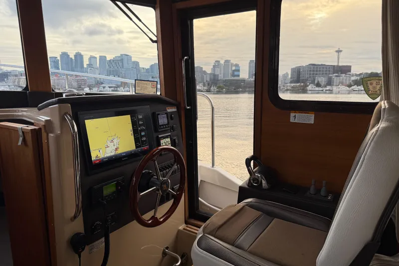 Slide: The Image of Interior of 2017 Ranger Tugs R-31 CB with city skyline view through window. - 9