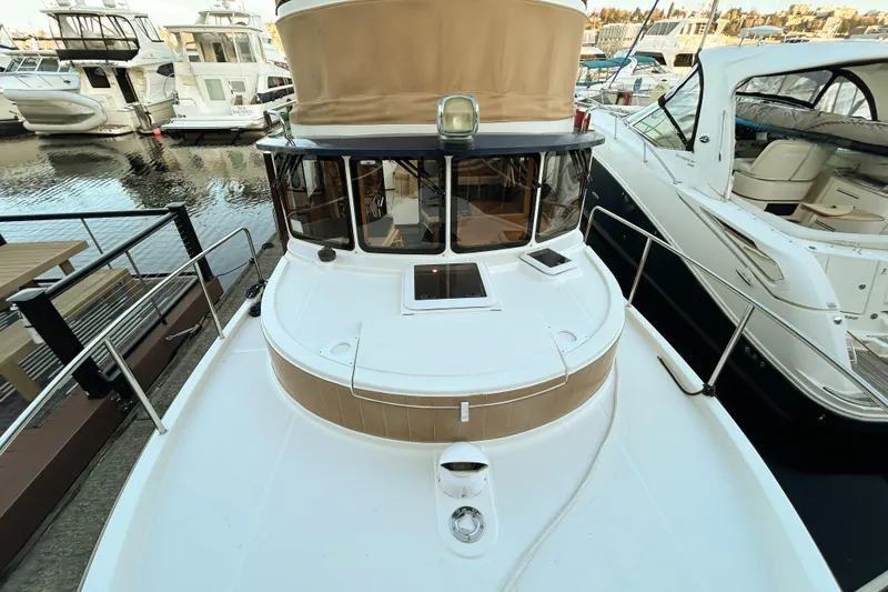 Slide: The Image of 2017 Ranger Tugs R-31 CB boat docked at marina, surrounded by other vessels. - 91