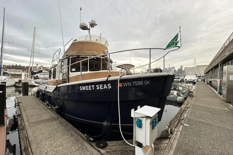 Slide: The Image of 2017 Ranger Tugs R-31 CB boat "Sweet Seas" docked at a marina. - 95