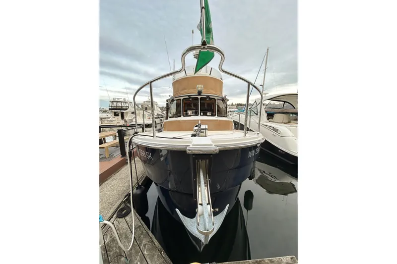 Slide: The Image of 2017 Ranger Tugs R-31 CB docked at marina, front view. - 96