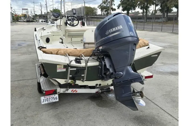 Slide: The Image of 2012 Xpress H20 boat with Yamaha outboard motor, parked on a trailer. - 11