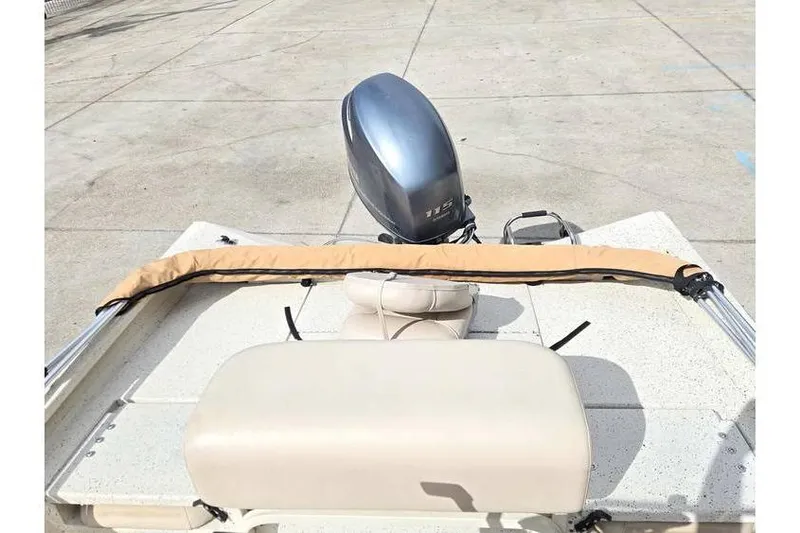 Slide: The Image of 2012 Xpress H20 boat with outboard motor and beige seating on concrete surface. - 16