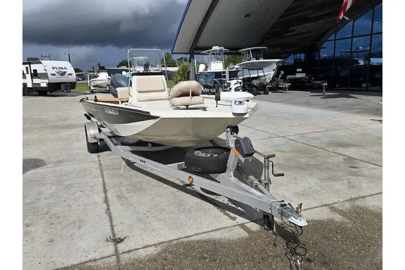 Slide: The Image of 2012 Xpress H20 boat on trailer, parked outdoors near dealership. - 3