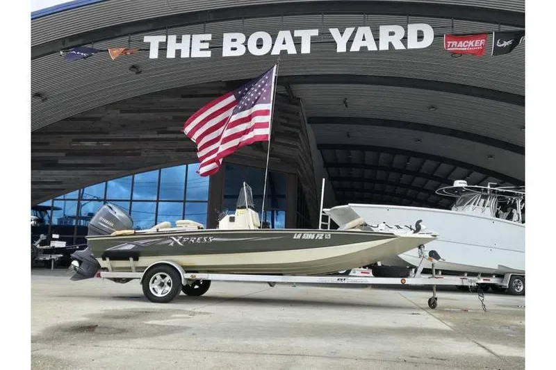 Slide: The Image of 2012 Xpress H20 boat on trailer at The Boat Yard with American flag. - 9