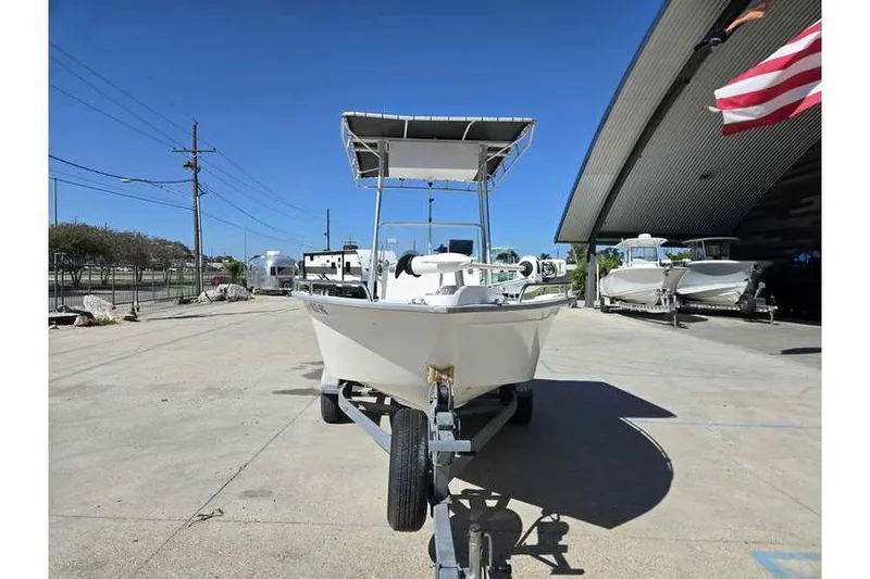 Slide: The Image of 2002 Cape Horn 17 CC boat on trailer, parked outdoors under clear blue sky. - 8