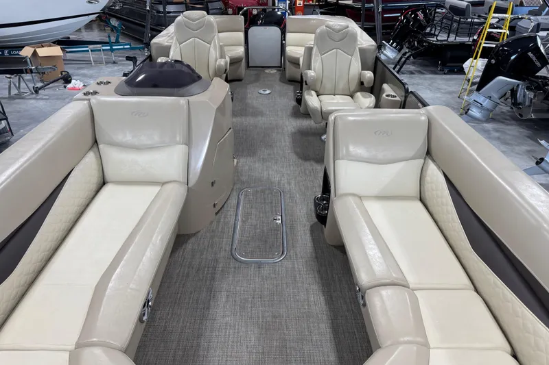Slide: The Image of 2019 Manitou 250 Encore SHP pontoon boat interior with beige seating and modern design. - 12