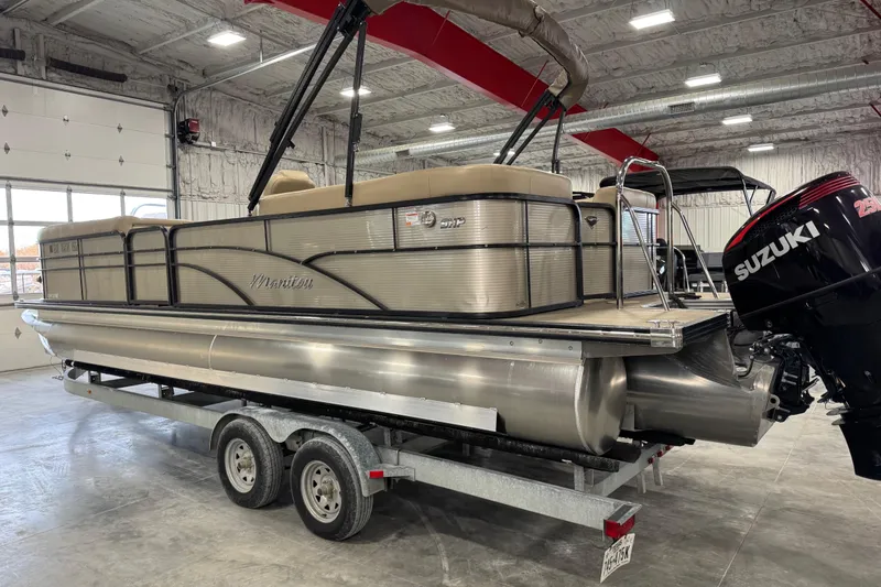 Slide: The Image of 2019 Manitou 250 Encore SHP pontoon boat with Suzuki engine on trailer in warehouse. - 4