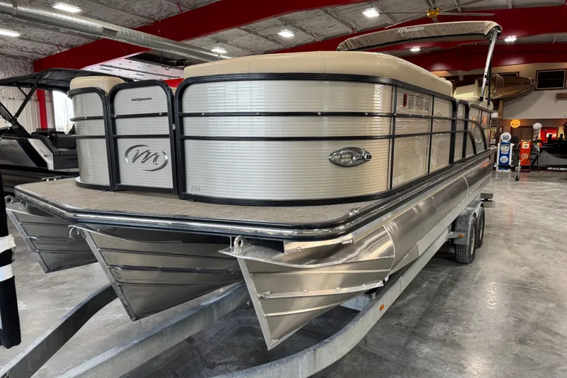 Slide: The Image of 2019 Manitou 250 Encore SHP pontoon boat on trailer in showroom. - 5