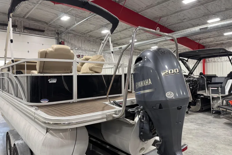 Slide: The Image of 2014 Bennington S 24 pontoon boat with Yamaha 200 engine in a garage setting. - 5