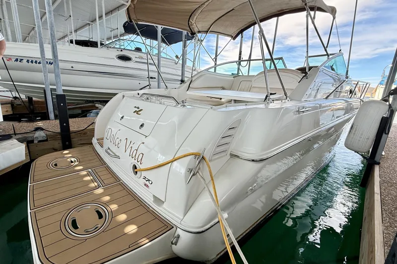 The Image of 2000 Sea Ray 270 Sundancer boat docked, featuring "Dolce Vida" on the stern. - 0