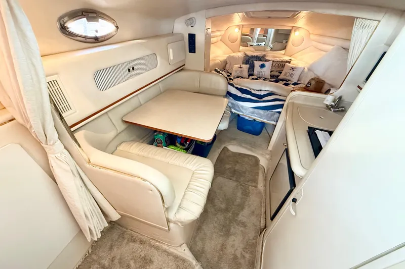 Slide: The Image of Interior of 2000 Sea Ray 270 Sundancer with cozy seating and sleeping area. - 11