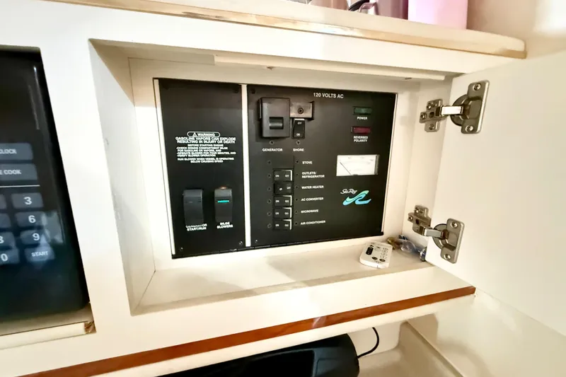 Slide: The Image of Electrical control panel inside 2000 Sea Ray 270 Sundancer boat cabinet. - 14