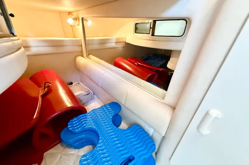 Slide: The Image of Interior cabin of 2000 Sea Ray 270 Sundancer with colorful cushions and soft lighting. - 16