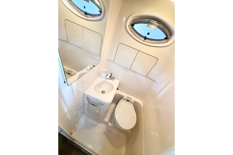 Slide: The Image of Compact bathroom in 2000 Sea Ray 270 Sundancer boat with sink and toilet. - 18