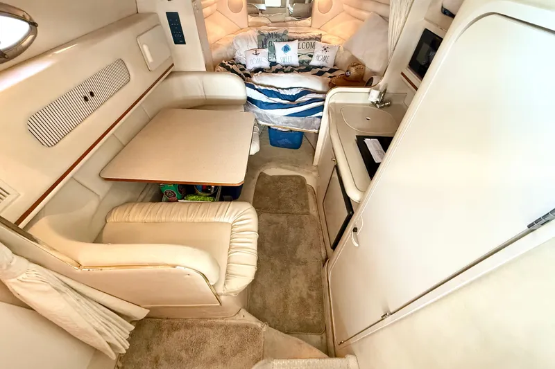 Slide: The Image of Interior of 2000 Sea Ray 270 Sundancer boat with cozy seating and kitchenette. - 19