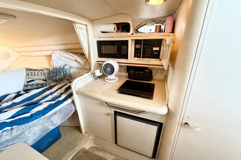 Slide: The Image of Interior of 2000 Sea Ray 270 Sundancer with kitchenette and cozy sleeping area. - 20
