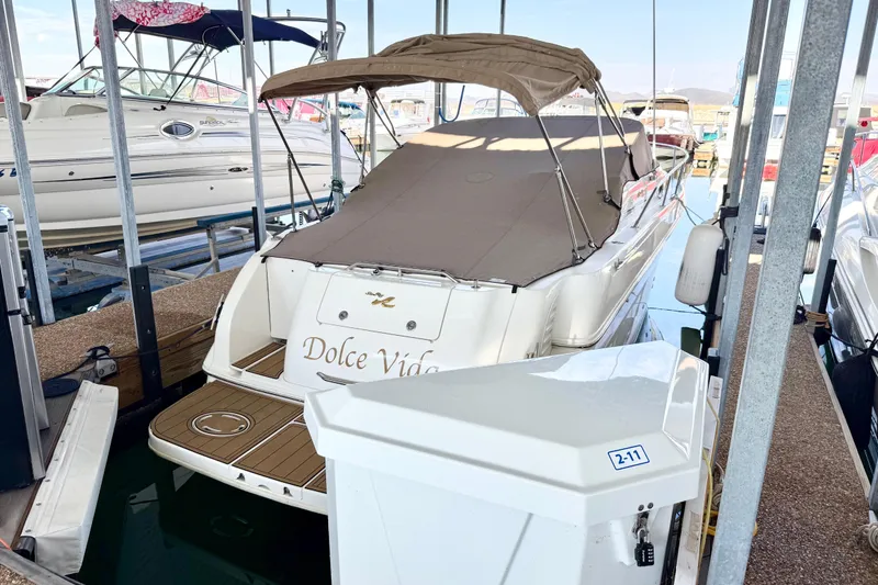 Slide: The Image of 2000 Sea Ray 270 Sundancer docked, covered, with "Dolce Vida" on the stern. - 23