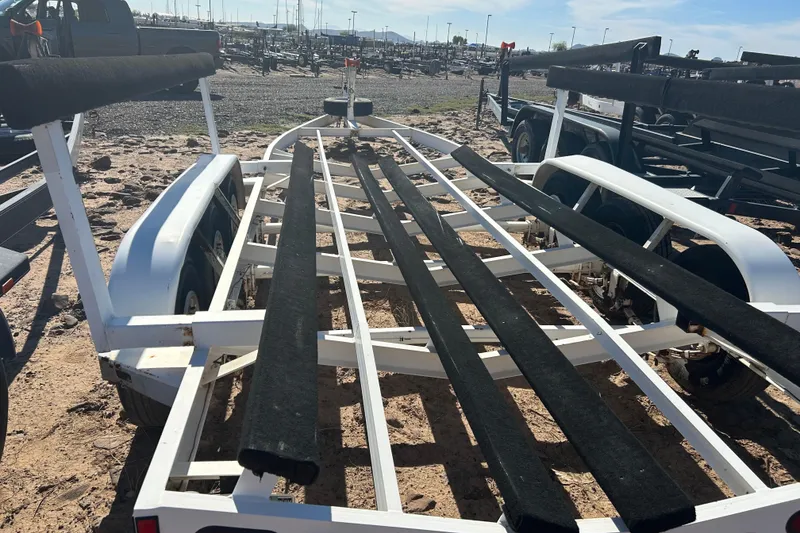 Slide: The Image of Boat trailer for 2000 Sea Ray 270 Sundancer on sandy ground. - 27