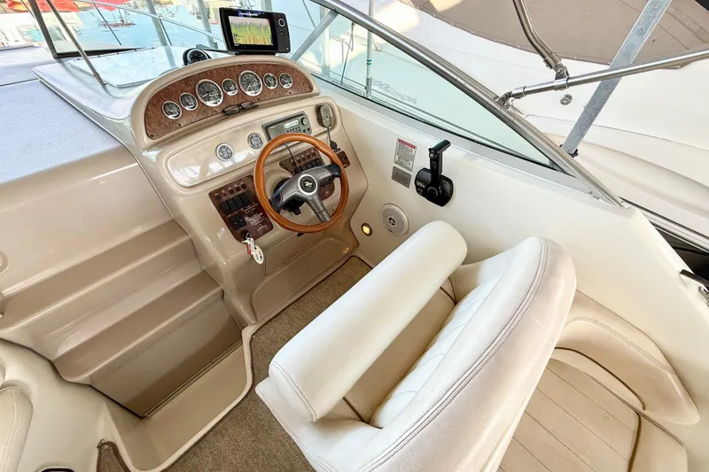Slide: The Image of Cockpit of 2000 Sea Ray 270 Sundancer with steering wheel and control panel. - 6