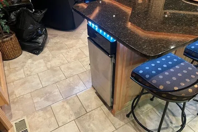 Slide: The Image of Modern kitchen interior on a 2008 Fantasy houseboat with granite countertop and bar stool. - 10