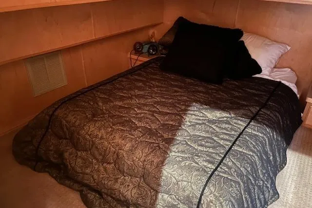 Slide: The Image of Cozy bedroom in 2008 Fantasy houseboat with patterned bedding and pillows. - 16