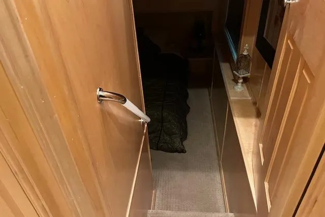 Slide: The Image of Cozy interior of a 2008 Fantasy houseboat with wooden walls and carpeted stairs. - 17