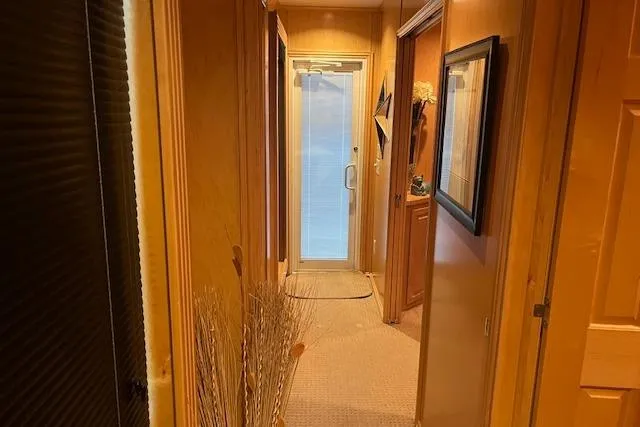 Slide: The Image of Narrow hallway inside a 2008 Fantasy Houseboat with wooden walls and carpet flooring. - 22