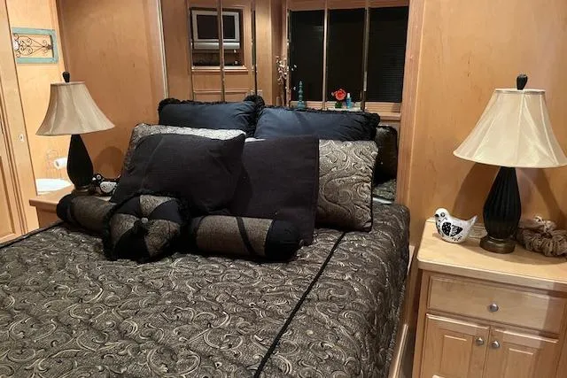 Slide: The Image of Luxurious bedroom interior in a 2008 Fantasy houseboat, featuring elegant bedding and stylish decor. - 27