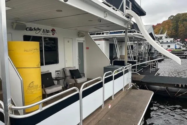 Slide: The Image of Houseboat docked with slide, seating area, and "Giddy Up" sign, Fantasy model, 2008. - 30
