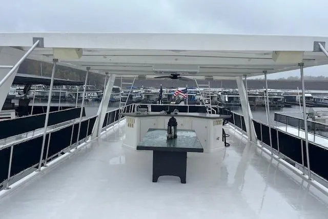 Slide: The Image of Spacious 2008 Fantasy houseboat deck with table, lantern, and marina view. - 34